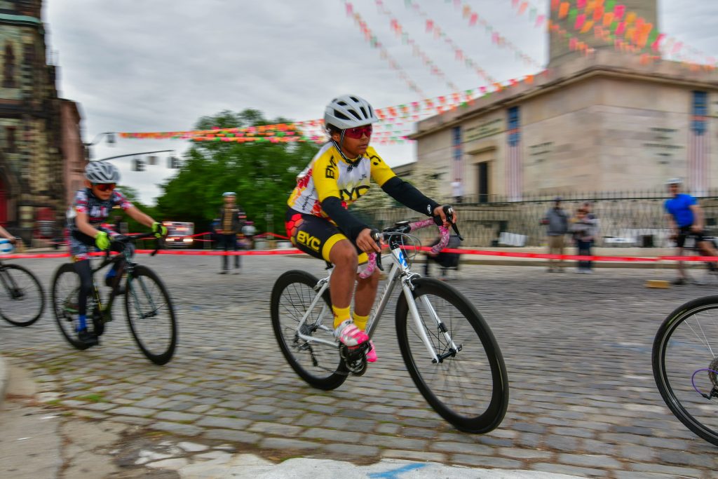 Blurry photo of a biker riding on a cobbled road